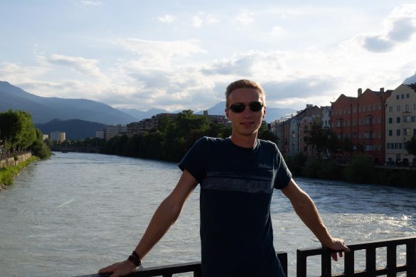 Ein Portrait von Markus auf einer Brücke in Innsbruck, die über den Inn führt.